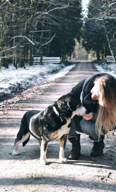 Charlotte mit ihrem alten Hund auf einer Straße